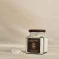 Glass jar of ancestral spring salt in flakes